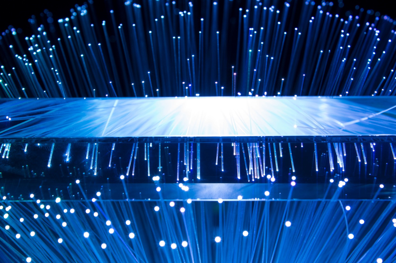 Blue fiber optic strands illuminating from a mirrored surface for Epo-Weld™ HTE high-temperature epoxy optical