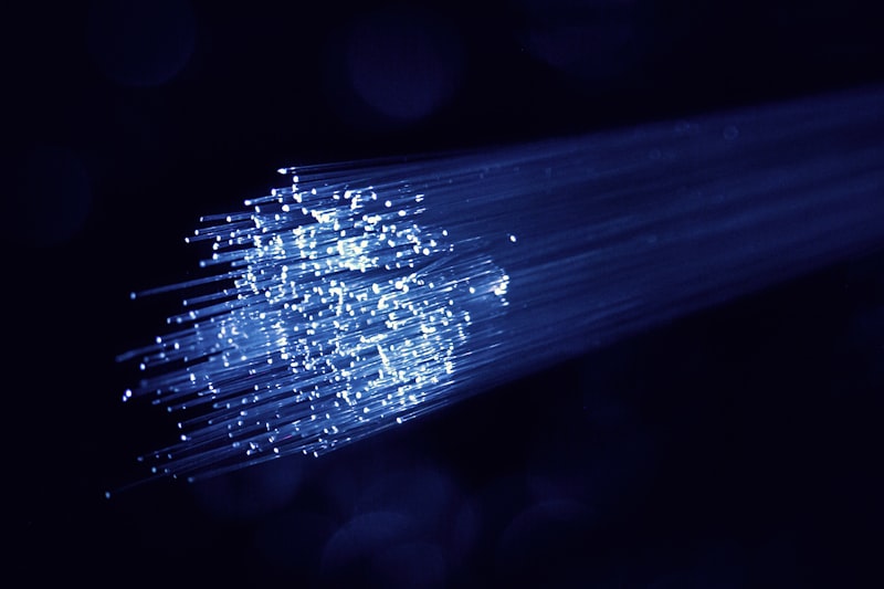 Bundle of illuminated fiber optic cables with blue light for Optik™ UV fiber optic splicing and coupling