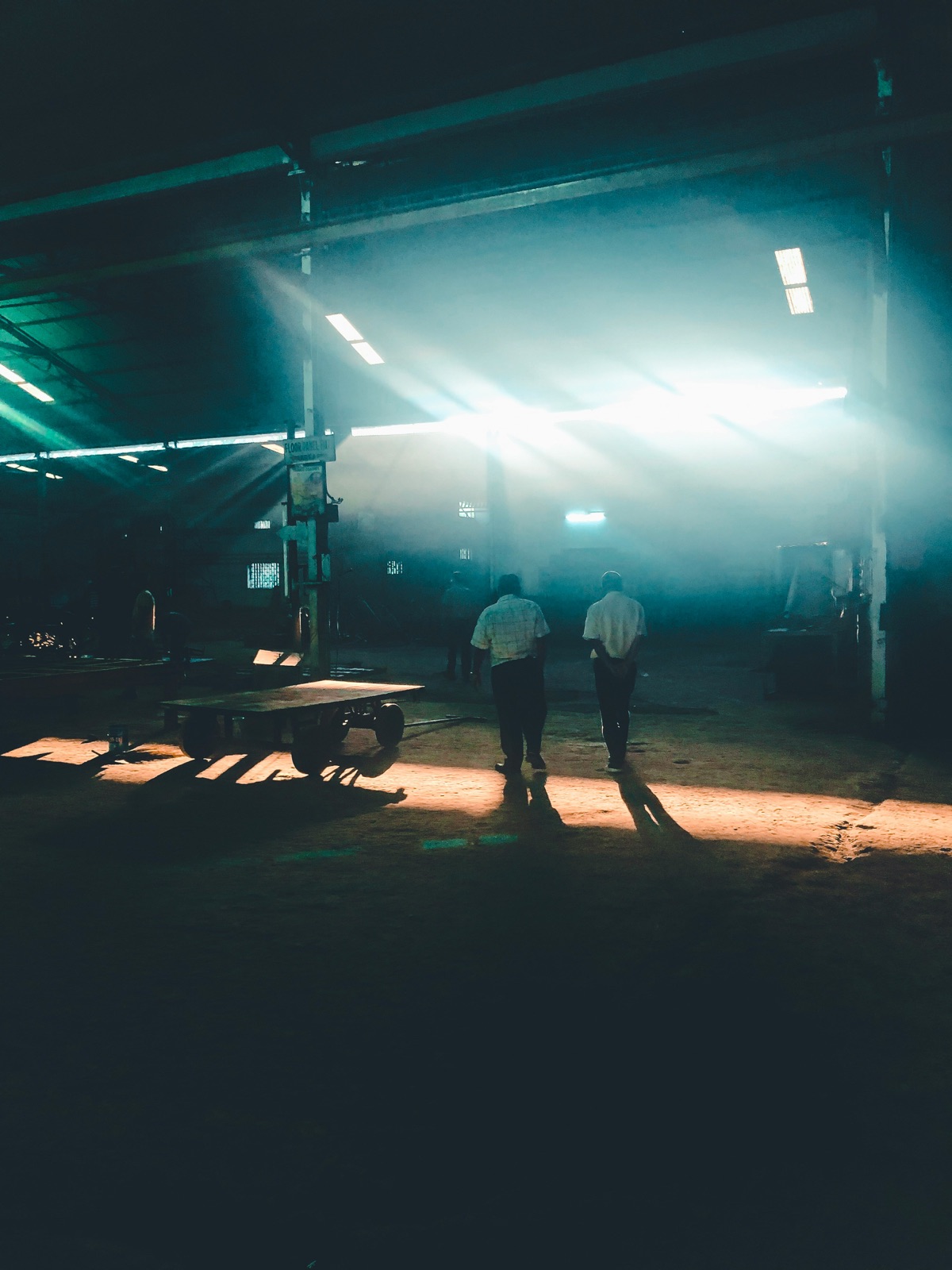 Industrial factory interior with moody teal light for Pyra-Sil™ UV silicone shadow and hidden joint sealing